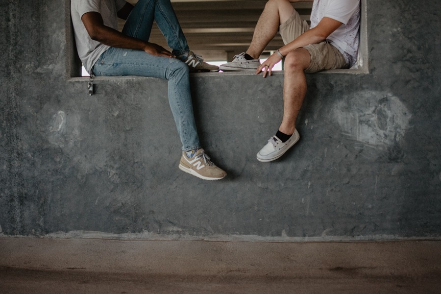 Two people talking on windowsill