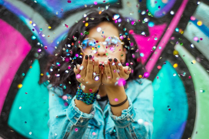 Woman blowing confetti