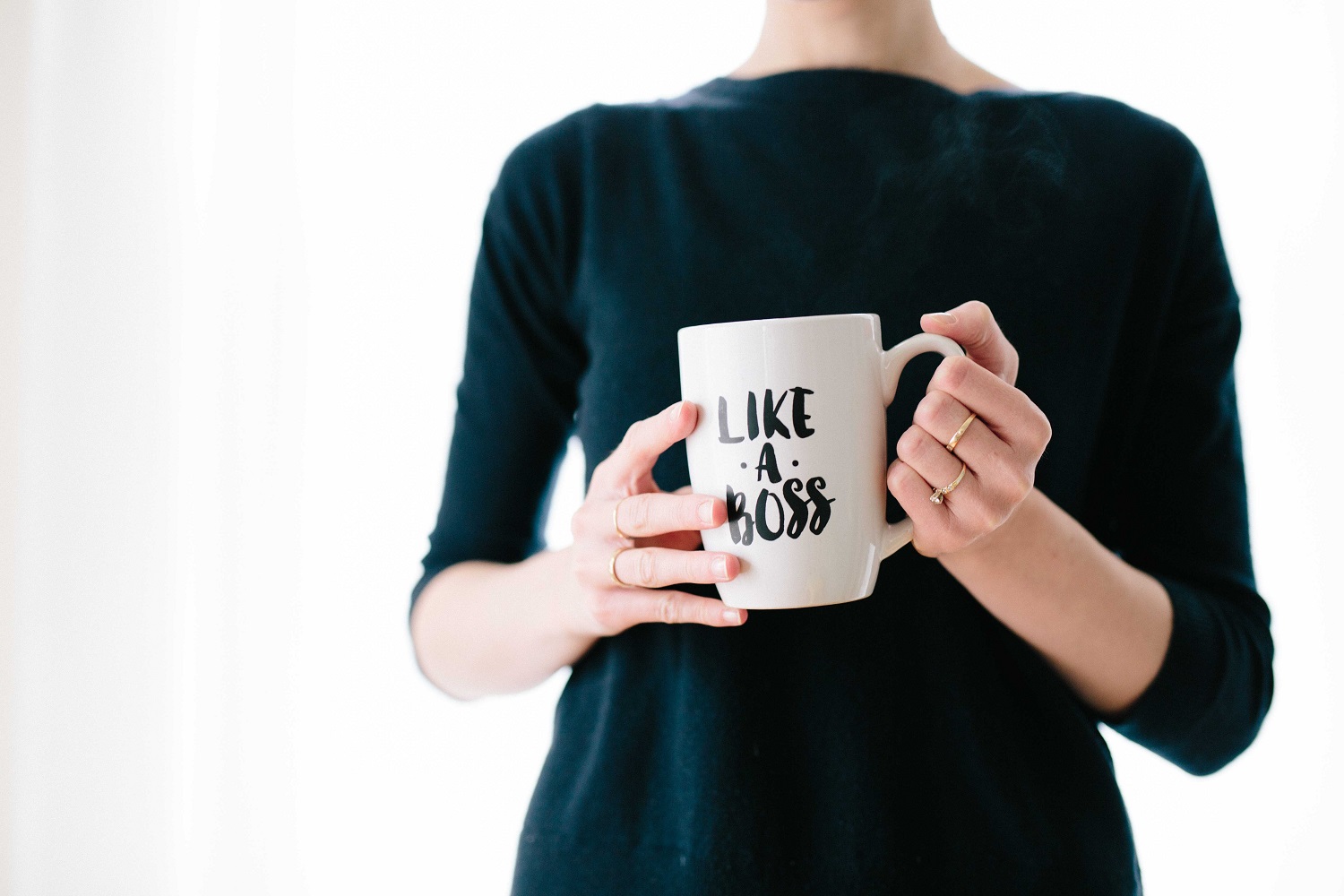 woman holding boss mug