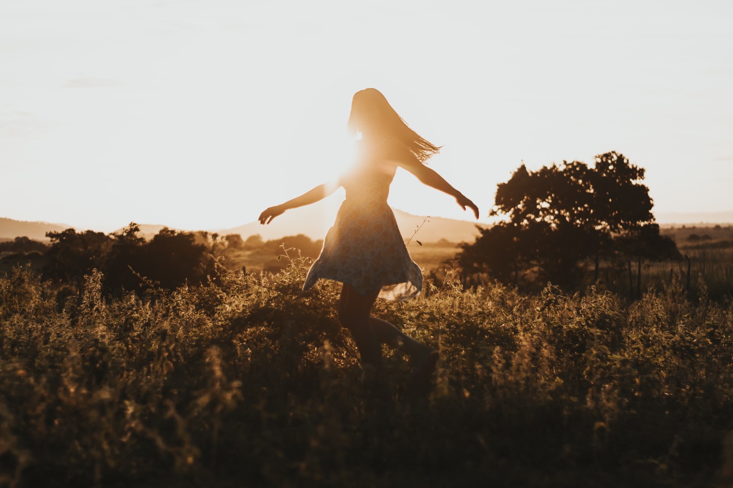 Girl in field at sunset