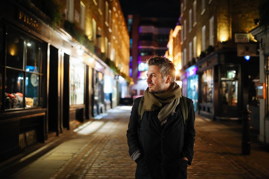 Man walking down street at night