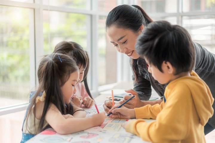 East Asian young woman with three kids